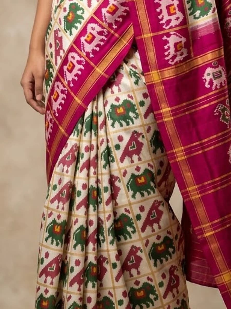 Close-up of ivory ikat fabric with elephants and parrots, Handloom Garden Puri